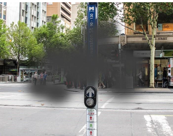 Demonstration of vision impacted by age-related macular degeneration with a street crossing and sign on a streetscape