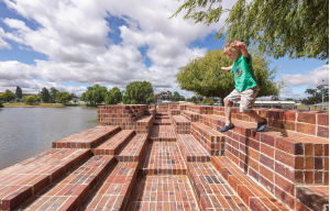 A brick spillway is articulated by steps, niches and platforms