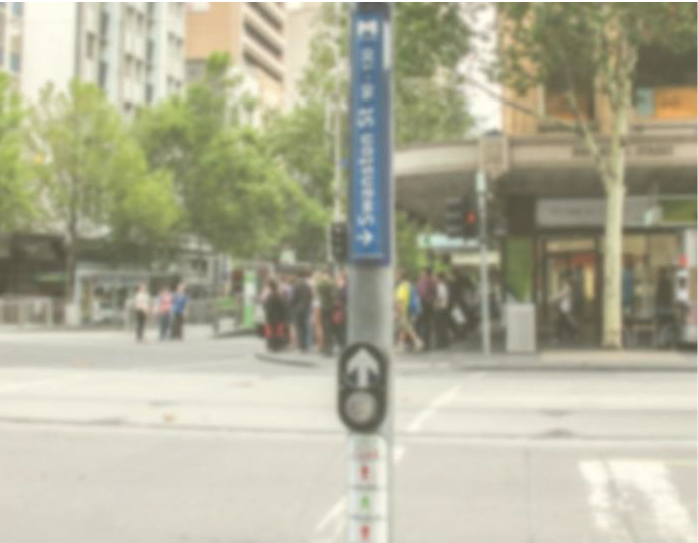 Demonstration of vision with cataracts with a street crossing and sign on a streetscape
