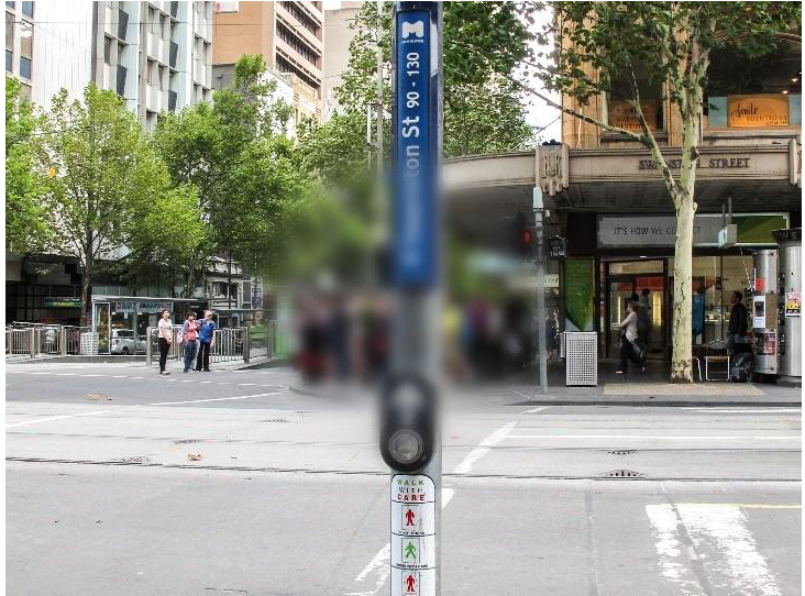 Demonstration of vision impacted by early stage age-related macular degeneration with a street crossing and sign on a streetscape